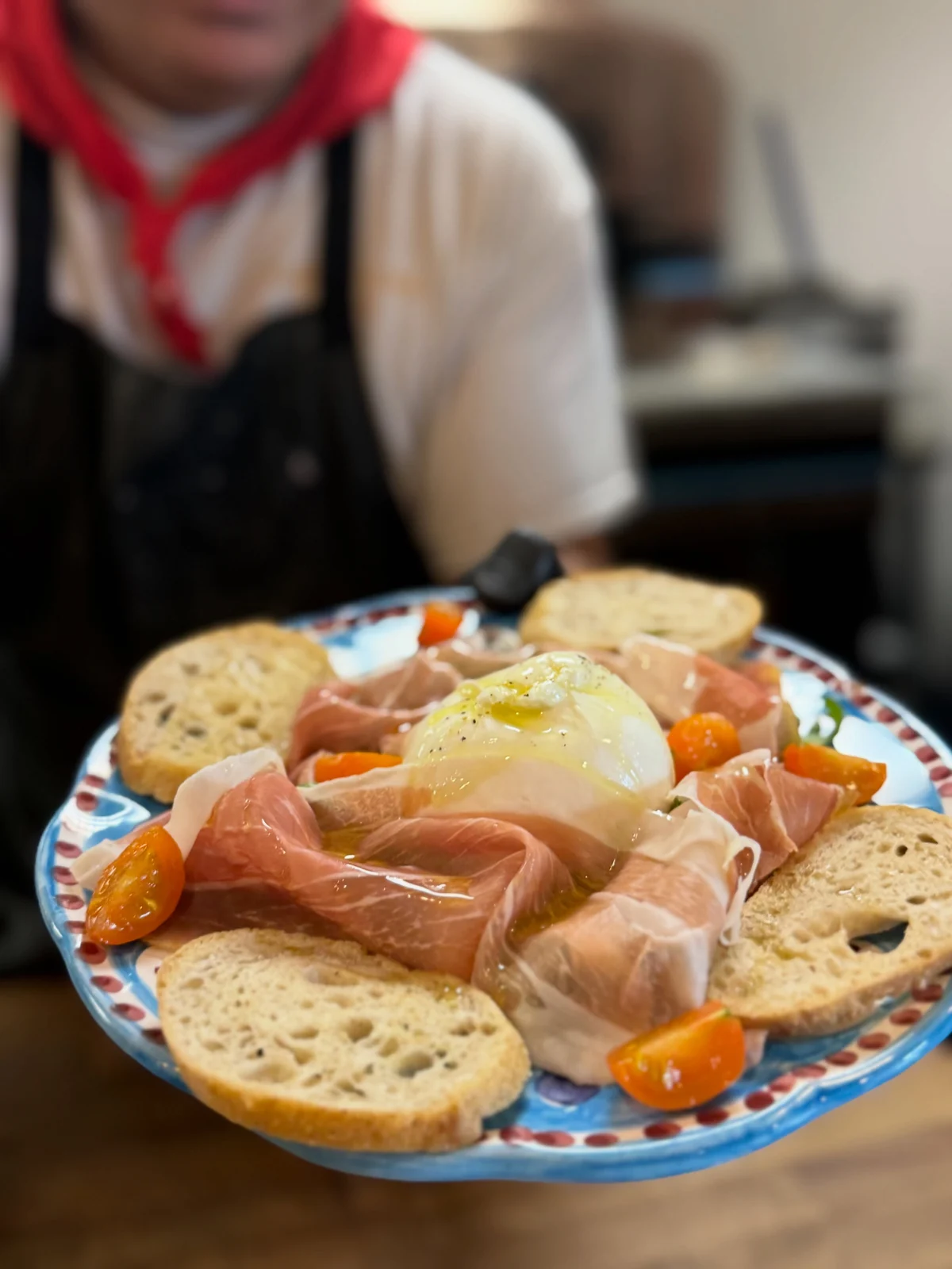 Burrata with prosciutto, tomatoes and crostini